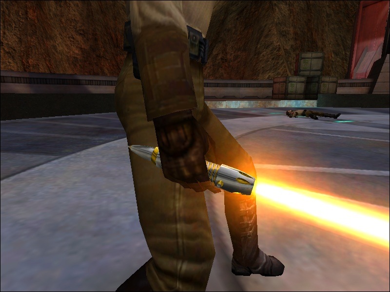An in-game screenshot of the lightsaber hilt with gold details.
